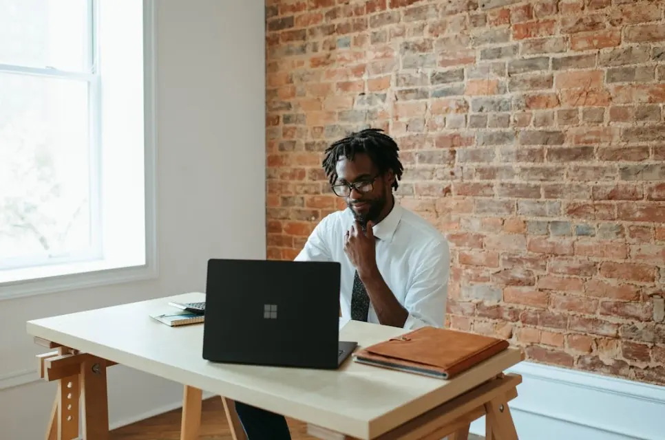 A man working on his computer, learning strategies to maximize sales velocity for higher revenue
