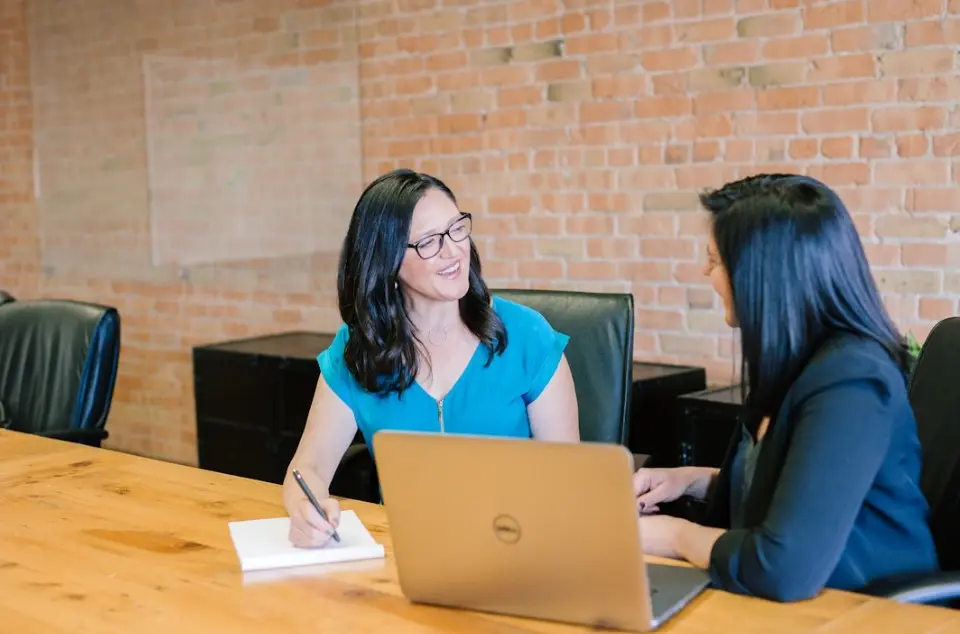 Team members in an office setting discussing the key components of sales velocity and how they are interconnected
